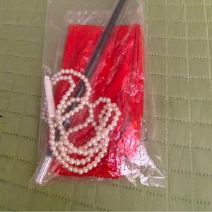 Costume accessories red long gloves, long cigarette holder & pearl necklace.
